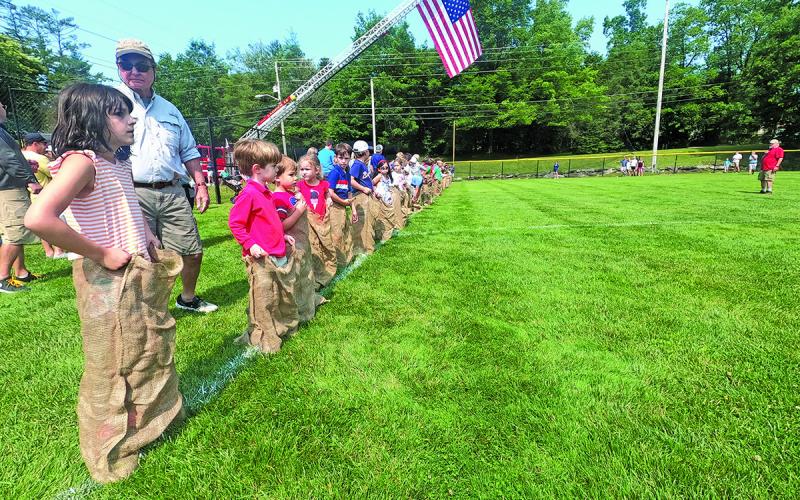 Photo by Christopher Lugo/Staff Kids lined up for the sack race at last year’s Fourth of July events.