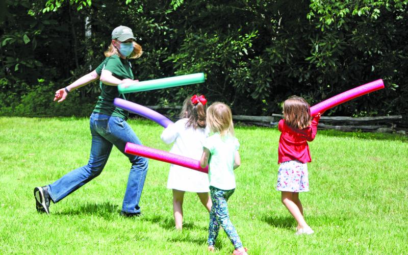 Photo by Kaylee Cook/Staff Education Specialist Paige Engelbrektsson plays with kids during the Buggy Bonanza Camp.