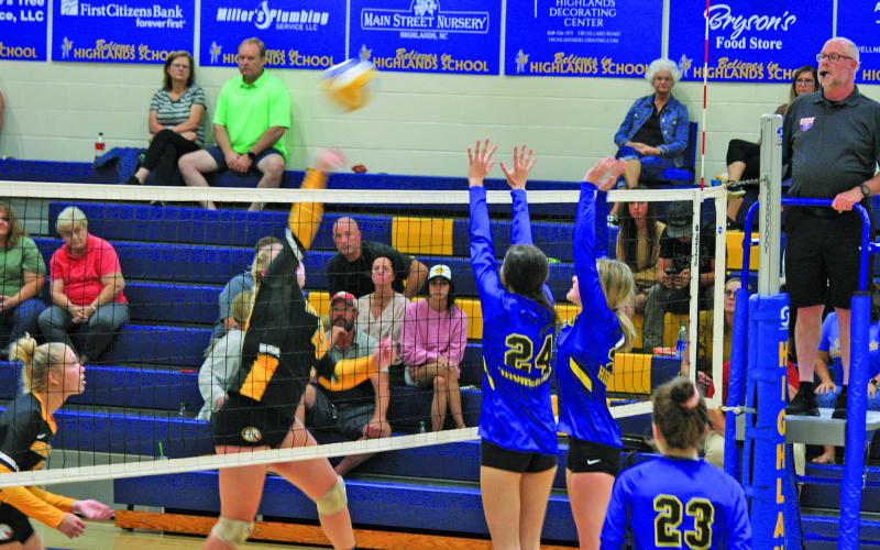 Lady Highlanders Ezra Branham (24) and Ashlynn Wilson (21) go up for a block against Murphy on Thursday night.