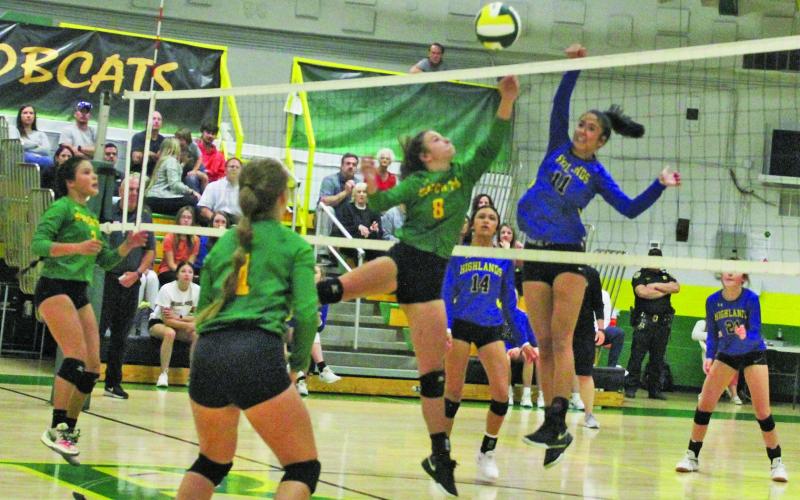 Highlands’ Caitlin Tingen (11) goes up for a kill as Blue Ridge defenders McKenzie Woods (6) and Isabella Moody (1) get into position during their match on Tuesday night.