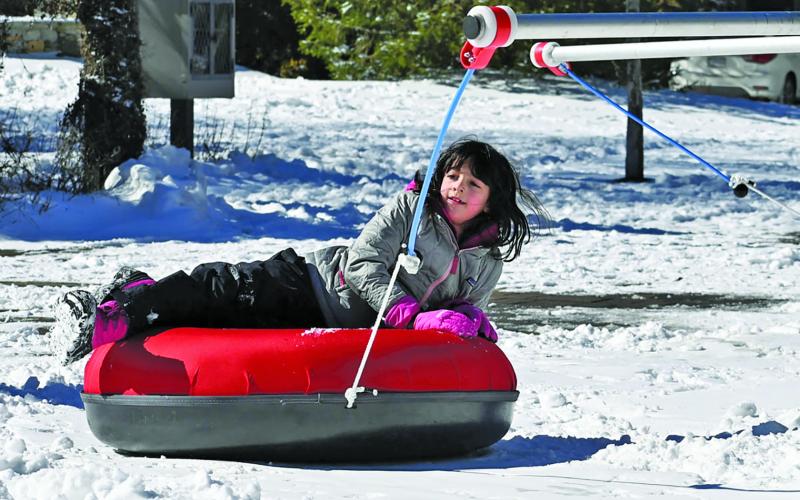 The snow tube merry-go-round will be back in action when Snow Fest at 4118 takes over Kelsey-Hutchinson Founders Park this weekend.
