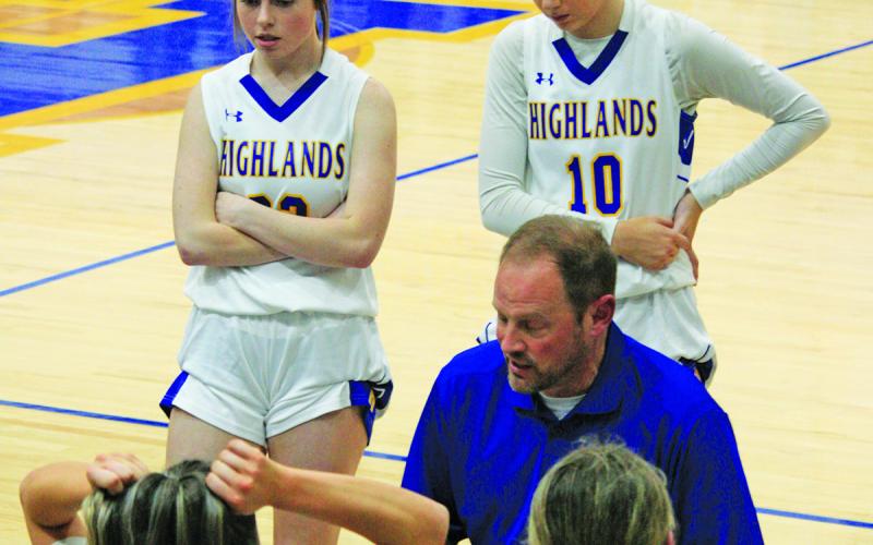 Highlands head coach Brett Lamb draws up a play during a playoff game against Hiwassee Dam.