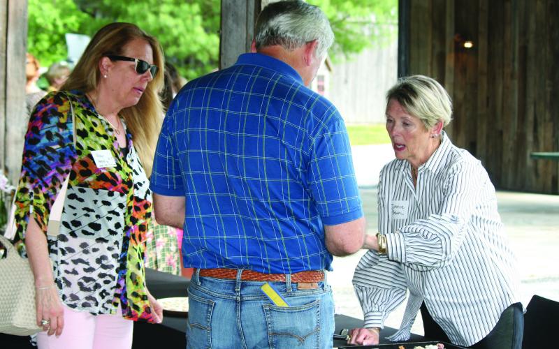 Jannie Bean (right) shows off some of her custom jewelry creations during the Spring Fling at The Bascom on Tuesday.