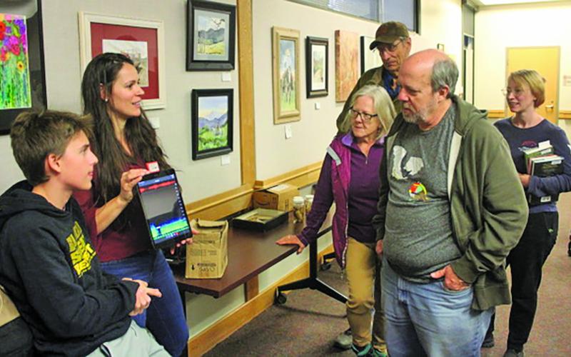 Dr. Rada Petric from the Highlands Biological Station shows attendees of a recent bat lecture at the Macon County Public Library, how they can detect bats flying overhead by sound and what species they area.