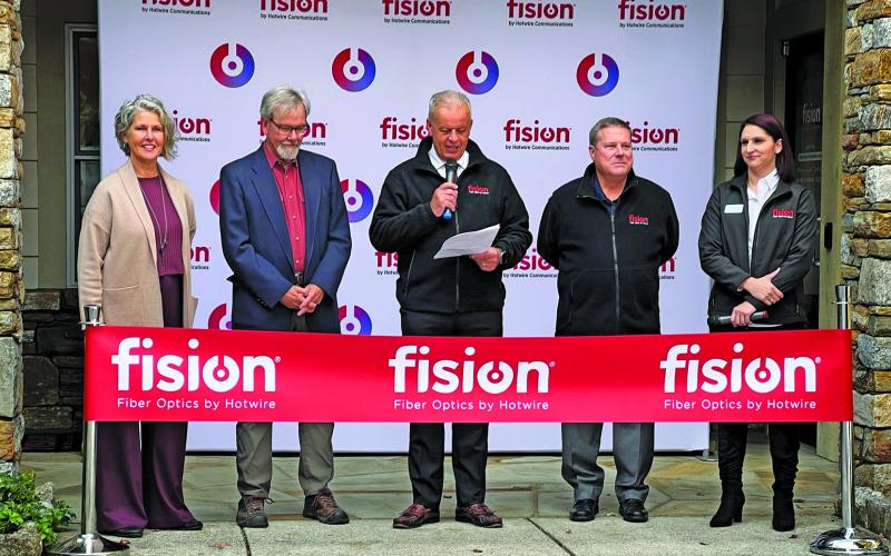 Highlands Chamber of Commerce Executive Director Kaye McHan and Mayor Patrick Taylor joined representatives from Fision by Hotwire for a ribbon cutting ceremony in front of the Highlands office.