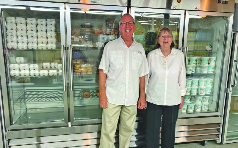 Marie Johnson shows Mountain Findings’ board member, Dan Rupp the new refrigeration unit purchased with Mountain Findings’ donation.