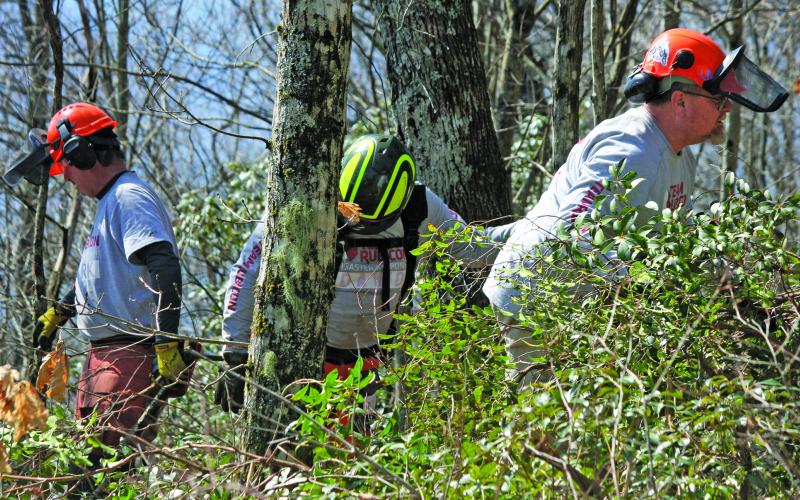 Members of Team Rubicon clear branches and brush away from buildings at The Mountain Retreat and Learning Center during a coordinated volunteer effort that spanned eight days from March 10-17.