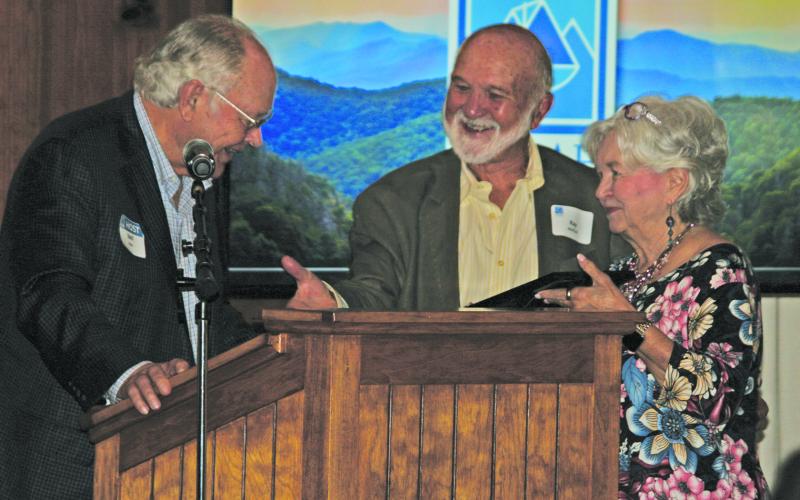 Stell Huie presents an award to Ray and Diane McPhail for their years of support to Pisgah Legal Services in Highlands and Cashiers during an organizational breakfast on Tuesday.