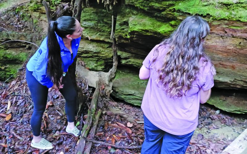 Researcher Reagan Jarrett and Dr. Rada Petric examine a rocky area to see if there are any bats present.