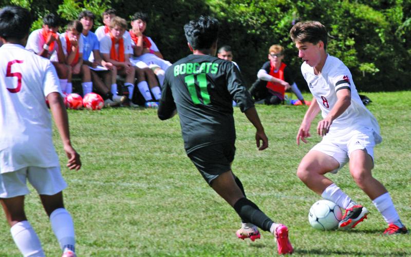Blue Ridge’s Miguel Juan-Julian (11) defends as Franklin’s Graham Caldwell looks to find a shooting lane during their game on Thursday.