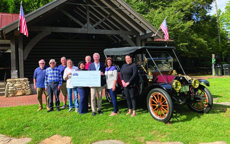 Pictured are Craig Nixon, Steve Ham, Lester Norris, Ricky Siegel, Faviola Olvera, Steve Mehder, David Moore, Cindy Trevathan, and Bonnie Potts. The vehicle is an original 1913 Buick owned by David and Amy Noznesky.