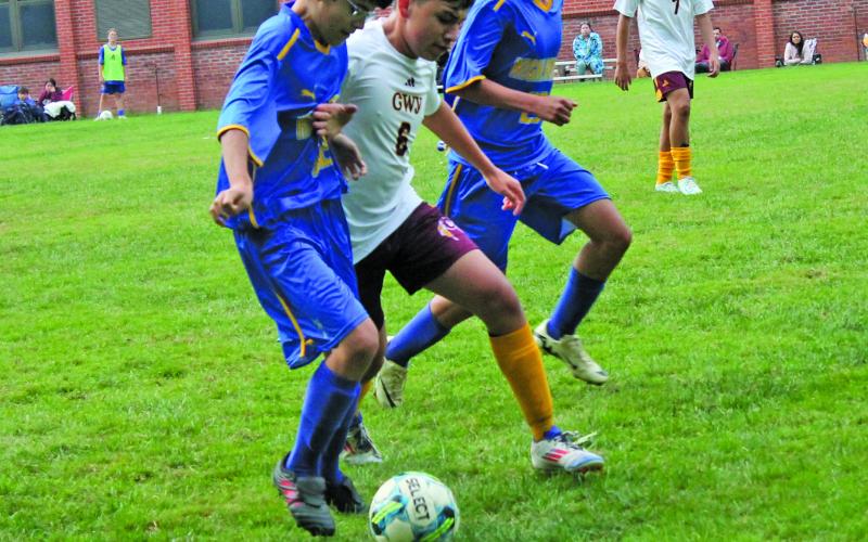 Highlanders sophomore Francisco Gooch (left) and junior Jesus Mendoza vie for the ball against a member of the Cherokee Braves during their match on Monday night.