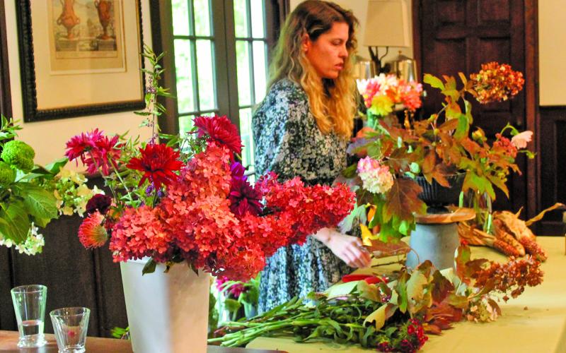 Christy Curcuru showed guests at “Snip, Sip, and Support” how to properly arrange fall flowers.