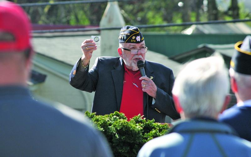 American Legion Post 370 chaplain Ed McCloskey shows off a newly minted coin commemorating the post’s 77th anniversary in Highlands.