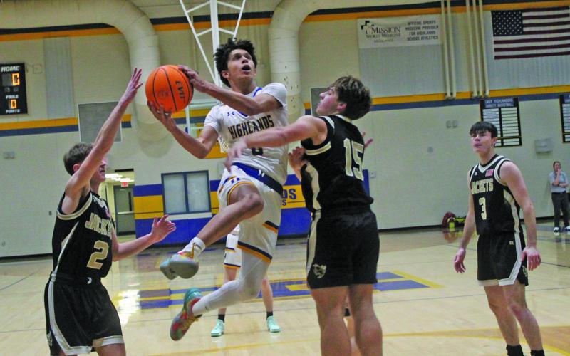 Highlands’ Gustaf McRae (0) drives between a pair of Hayesville defenders during their game on Tuesday night.