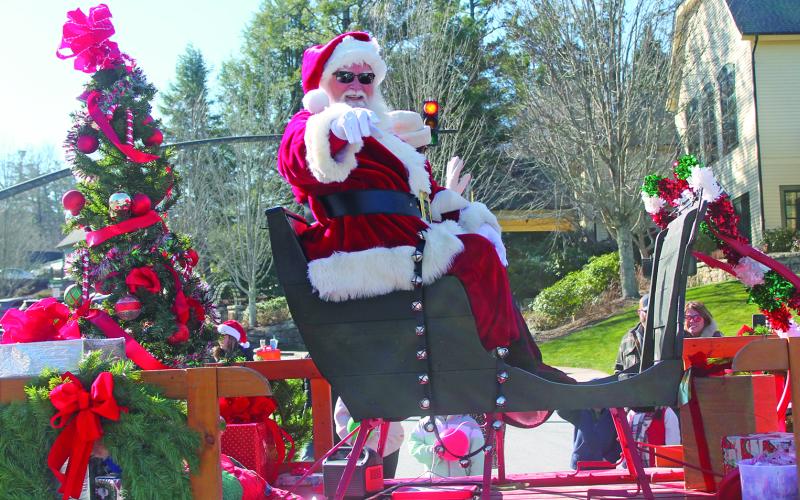 Santa Claus himself gives a shoutout to some young revelers during the Highlands Christmas Parade on Saturday.