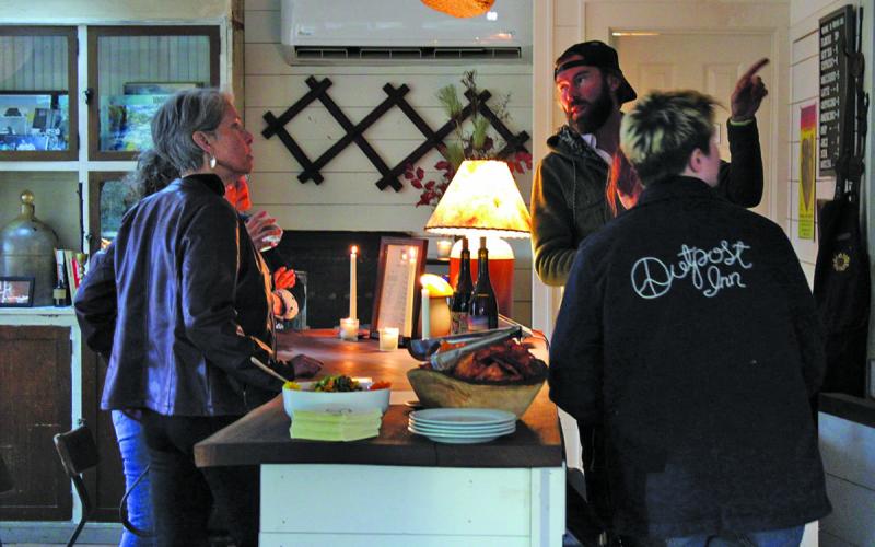 Highlands Chamber of Commerce Executive Director Kaye McHan (left) and a group of select invitees got the first look at the wine bar at the Outpost Inn.