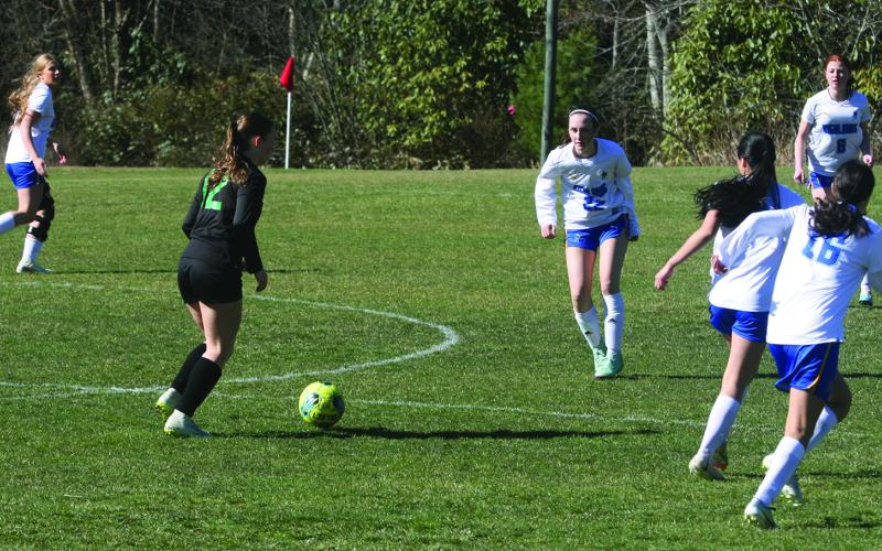 Blue Ridge forward Isabella Moody (12) looks for a passing lane as Highlands defender Olivia Corbin (22) closes the gap on Monday afternoon.