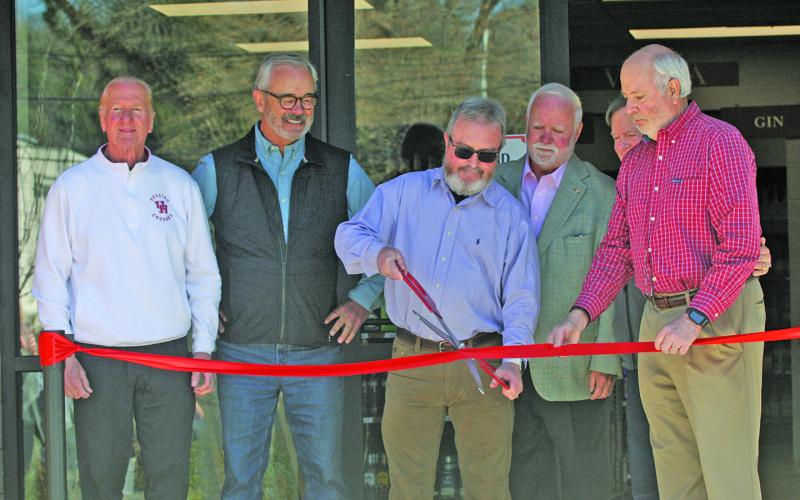 Photo by Ryan Hanchett/Staff Highlands ABC General Manager Kevin Vinson cuts a ribbon at the new store location on Oak Street. He was joined on Thursday by ABC board members Rick Trevathan, Jim Ward, Dave O’Harra, Andy Chmar and Steve Mehder.