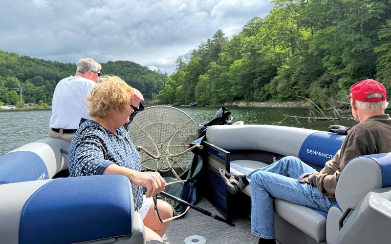 David and Kelly Feist search for debris on the lake with volunteer Ike Eichhorn.