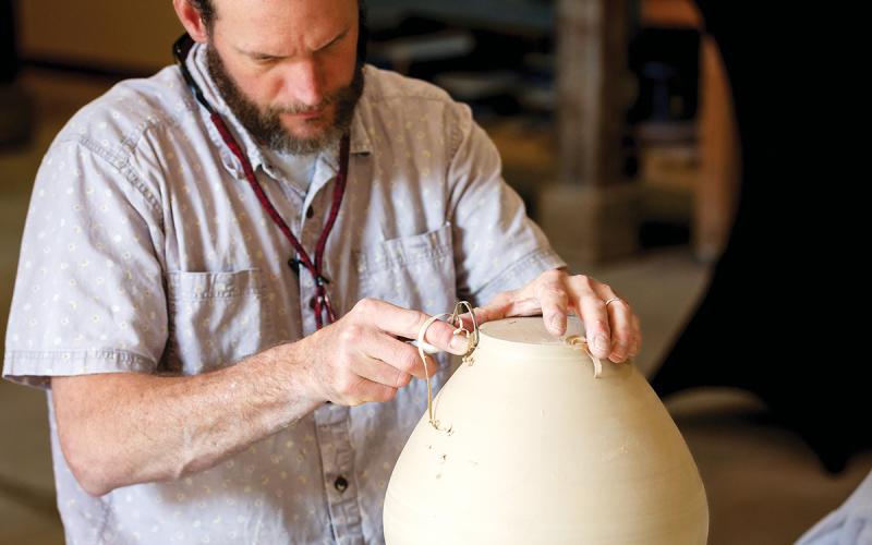 Frank Vickery, Director of Ceramics, creates a vase.