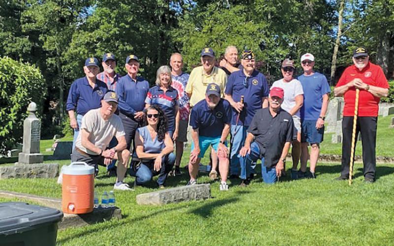 Legionnaires and volunteers gathered to place flags at veterans’ grave sites at the Highlands Cemetery.