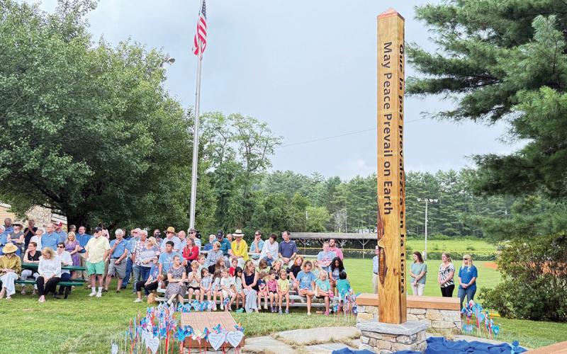 Rotarians, children and community members gathered for the dedication of the Peace Pole at the Community Building in Highlands  |  Photo by Kevin McCall
