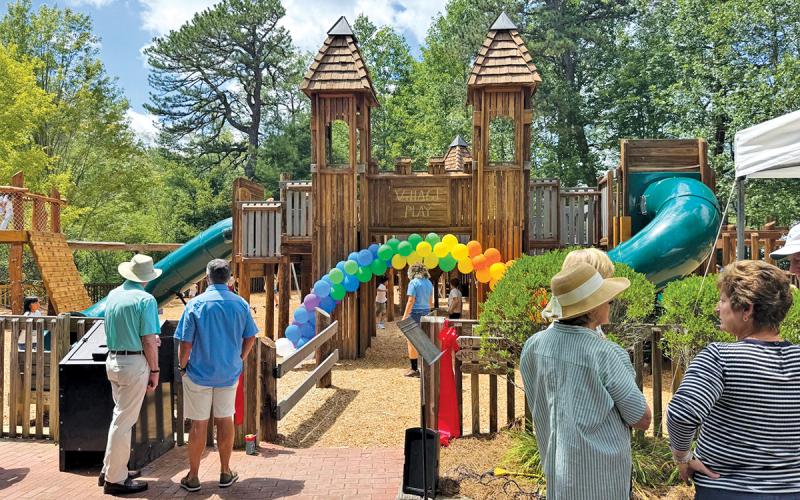 Community members gather at the playground to celebrate its opening.