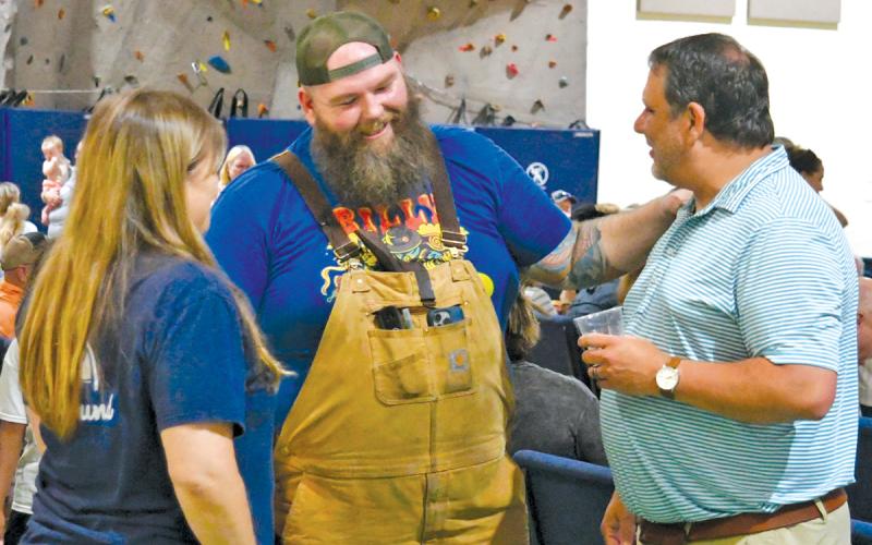 Kyle Bryner, winner of this season’s “BBQ Brawl” talks with Todd Faircloth, executive director of the Foxfire Museum, at the July 27 watch party for the Food Network broadcast.
