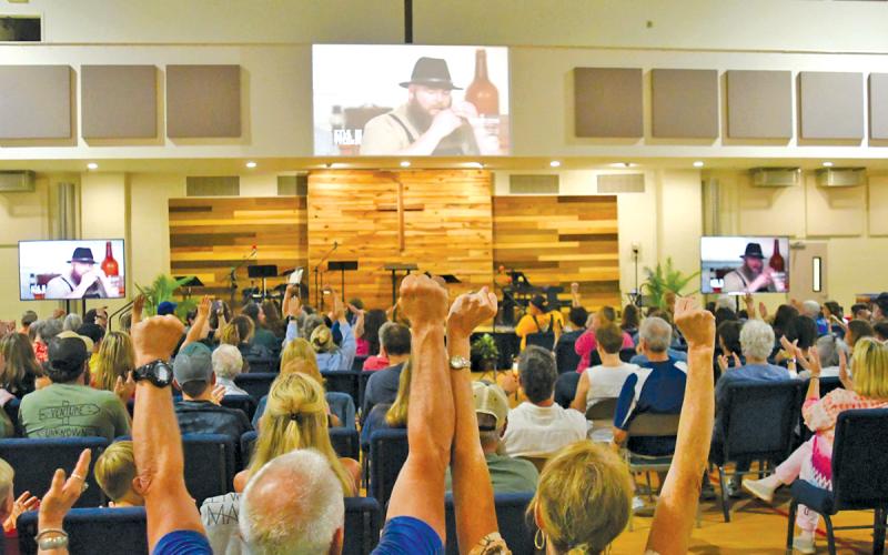 The watch party crowd cheers when Kyle Bryner is announced as “Master of the ‘Cue” on season six of the Food Network’s “BBQ Brawl.”