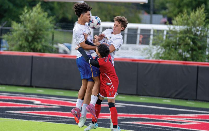 Photo courtesy of Todd Sumner  |  Highlander senior Paolo McRae (left) and junior Blaine Dendy (17) were on a collision course with a Pisgah player as they battled for a pass.