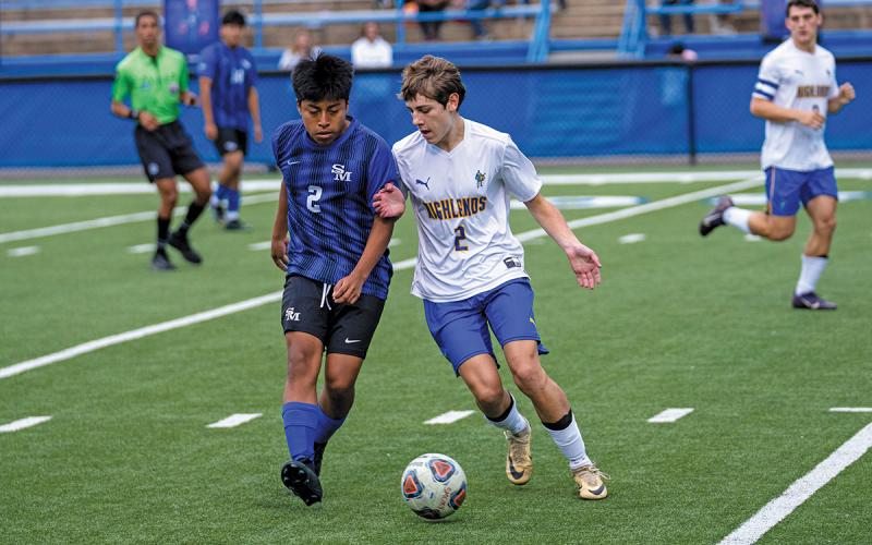 Photo courtesy of Todd Sumner  |  Stephen Pierson (right) moves the ball past a Smoky Mountain High opponent in Monday’s game.