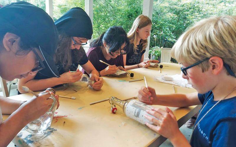 Campers create etched glass projects with Bascom Engagement Associate Caryn Raming.