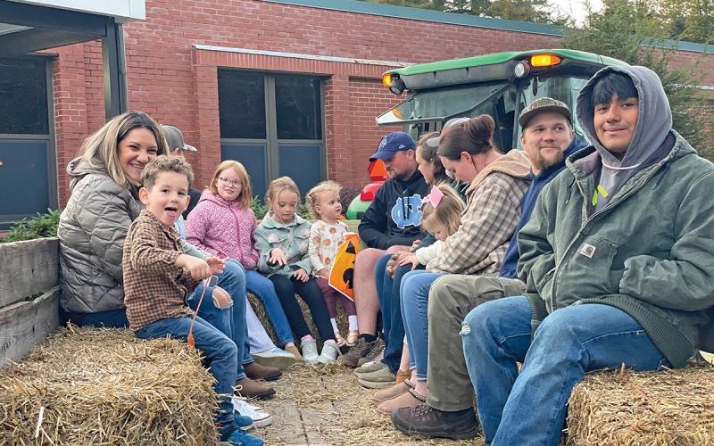 Highlands School teacher Angela Swain and son Cash (left), Senior Bryan Jarquin Colmenares (right) and others enjoy the hayride at this year’s Fall Festival.