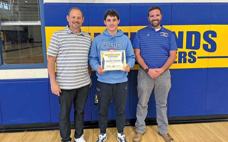 Highlands School Athletic Director Brett Lamb and Ryan Bryson award senior Isaiah Vilardo with the Student-Athlete of the Month award.
