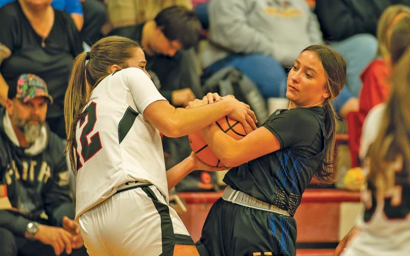 Guard AE Woods wrestles for the ball in Highlands’ opener against Andrews on Nov. 18 in Andrews, NC.