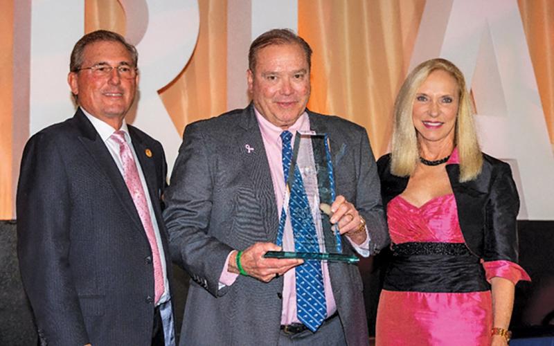 2025 Chairman of the Board Nick Sarra and President &amp; CEO Carol Dover present the FRLA Restaurateur of the Year award to Mike Quillen.