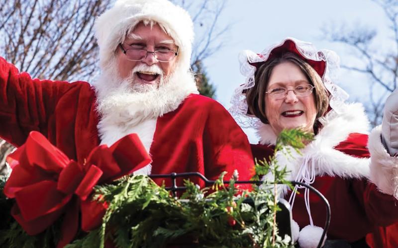 Mr. and Mrs. Clause cheerily wave to parade attendees at the Highlands Christmas Parade  |  Photo courtesy of Visit Highlands NC