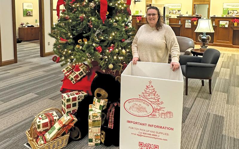 Regions Bank branch manager Jessica Farrell stands amongst donated gifts for the Macon County Elves toy donation program at the Highlands Regions Bank location.