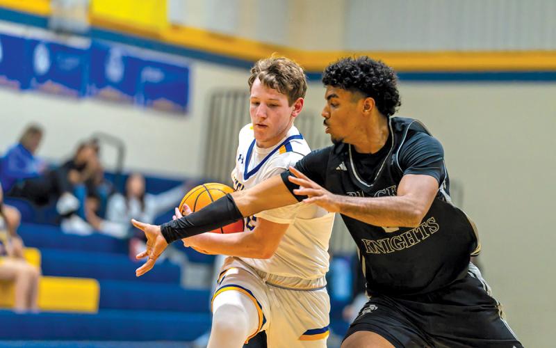 Senior Aiden Crook-Jenkins dodges a Robbinsville defender while driving to the basket in the Varsity Boys’ 65-55 loss.  |  Photo by Todd Sumner