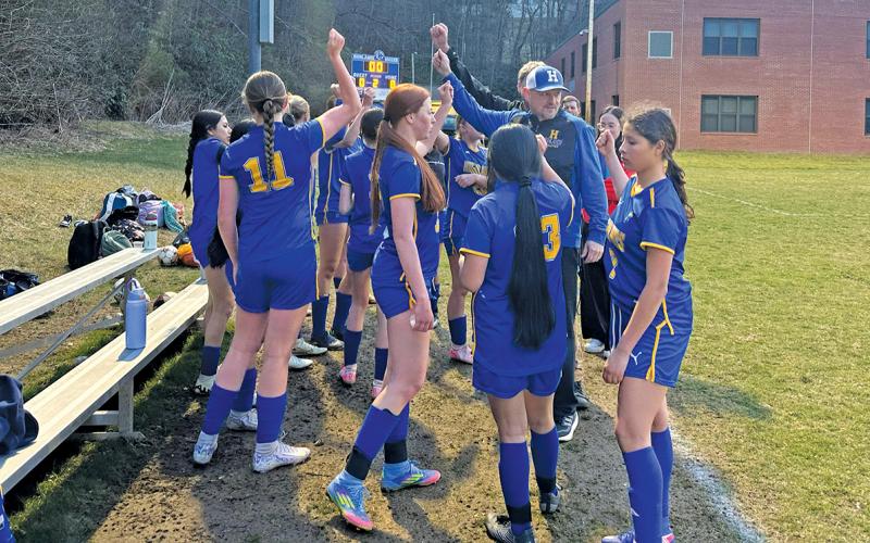 The Lady Highlanders huddle together following their 8-0 victory over Plateau-rival BREC on March 24.  |  Photo by MItch Stone/Staff