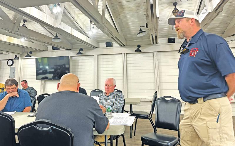 Chief Ryan Gearhart introduces the proposed fire tax to town commissioners, current and retired firefighters, and other residents at Highlands Community Building.