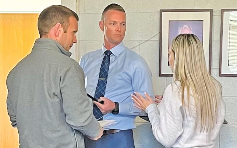 Commissioner Josh Young, superintendent Josh Lynch and MCS finance officer Laney Ledford speak after a liaison meeting.  |  Photo courtesy of Shelby Powell/The Franklin Press