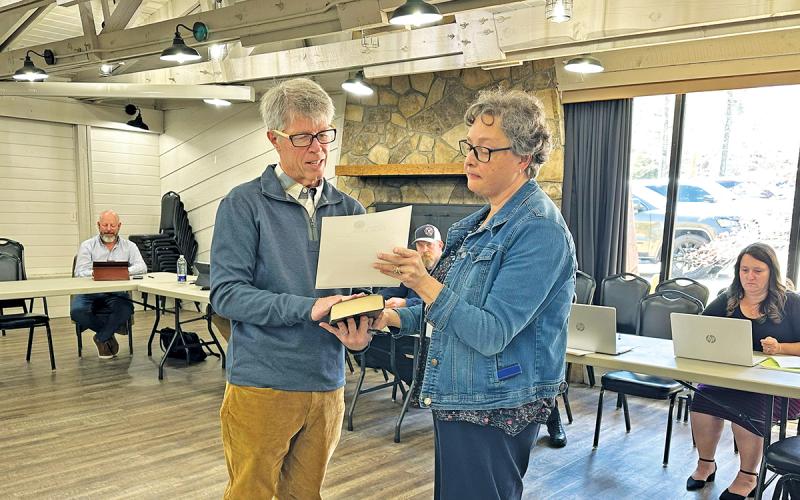 Newly-elected commissioner Bill Grubb is sworn in by Town Clerk Gibby Shaheen during the April 9 budget workshop.