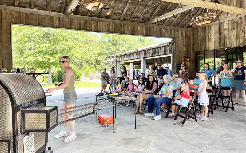 Dillsboro Creative Arts Center’s Annie Jacobsen shapes glass using repurposed energy at last year's event. The Bascom will host Community Day on July 3 starting at 11 a.m. Photo courtesy of The Bascom