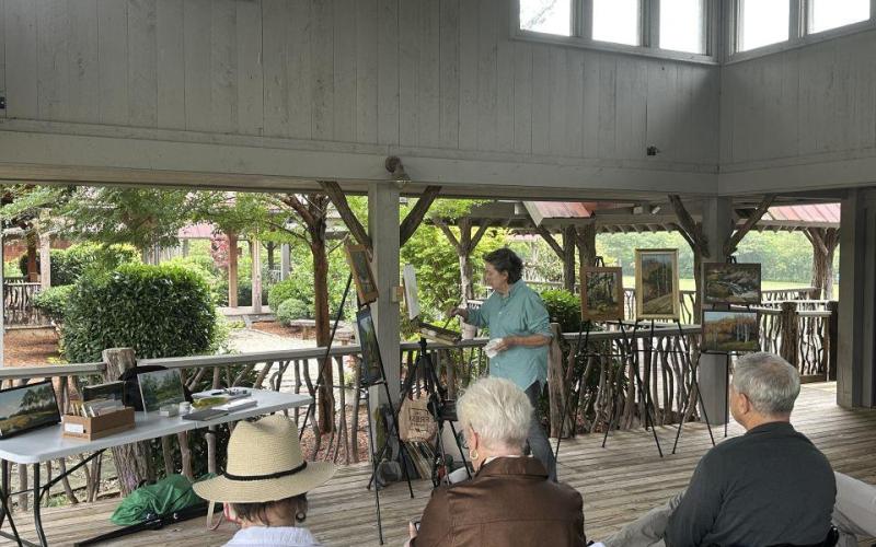 Lila McAlpin discusses the challenges of starting and finishing paintings during her demonstration at The Village Green on Monday, July 13.