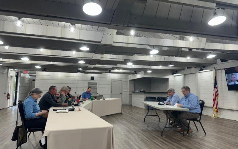 The town board listens to McGill Associates’ presentation on the Mirror Lake dredging project during the July 16 board meeting.