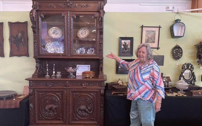 Hazel Giles, who has her own booth at the Cashiers Annual Antique Show, displays a selection of Black Forest carvings that originated in 19th-century Switzerland.