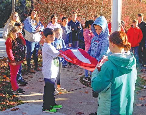 Fifth grade students at Highlands School got a lesson in the proper way to fly, lower and fold the American flag on Friday, Nov. 8.