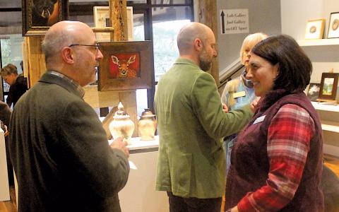 Highlands Biological Station Executive Director Jim Costa and Highlands Chamber of Commerce board chair Hilary Wilkes discuss upcoming initiatives during a community partners event at The Bascom Center for the Visual Arts on Monday night.